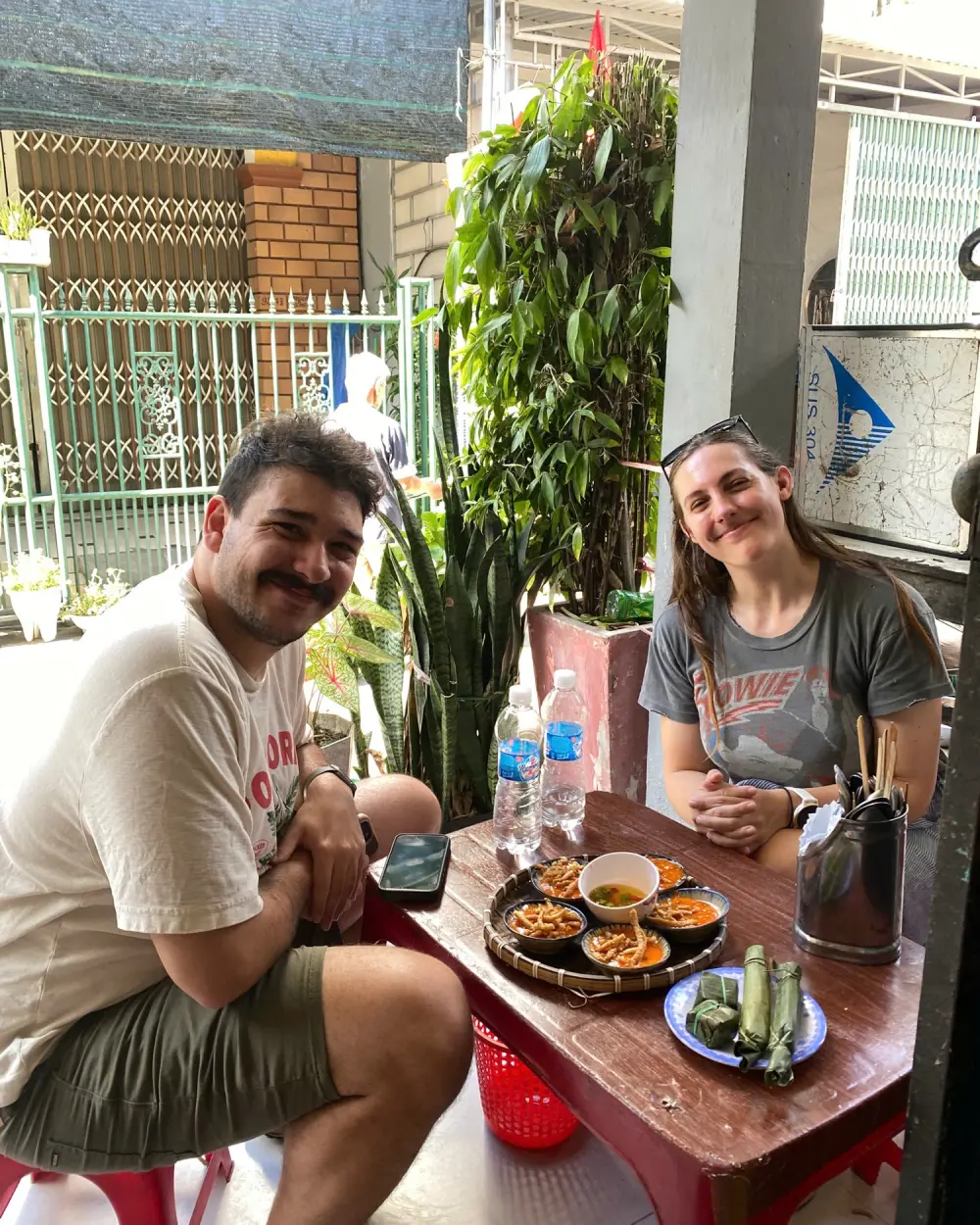Guests at a street table with small plates of local dishes