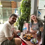 Guests at a street table with small plates of local dishes