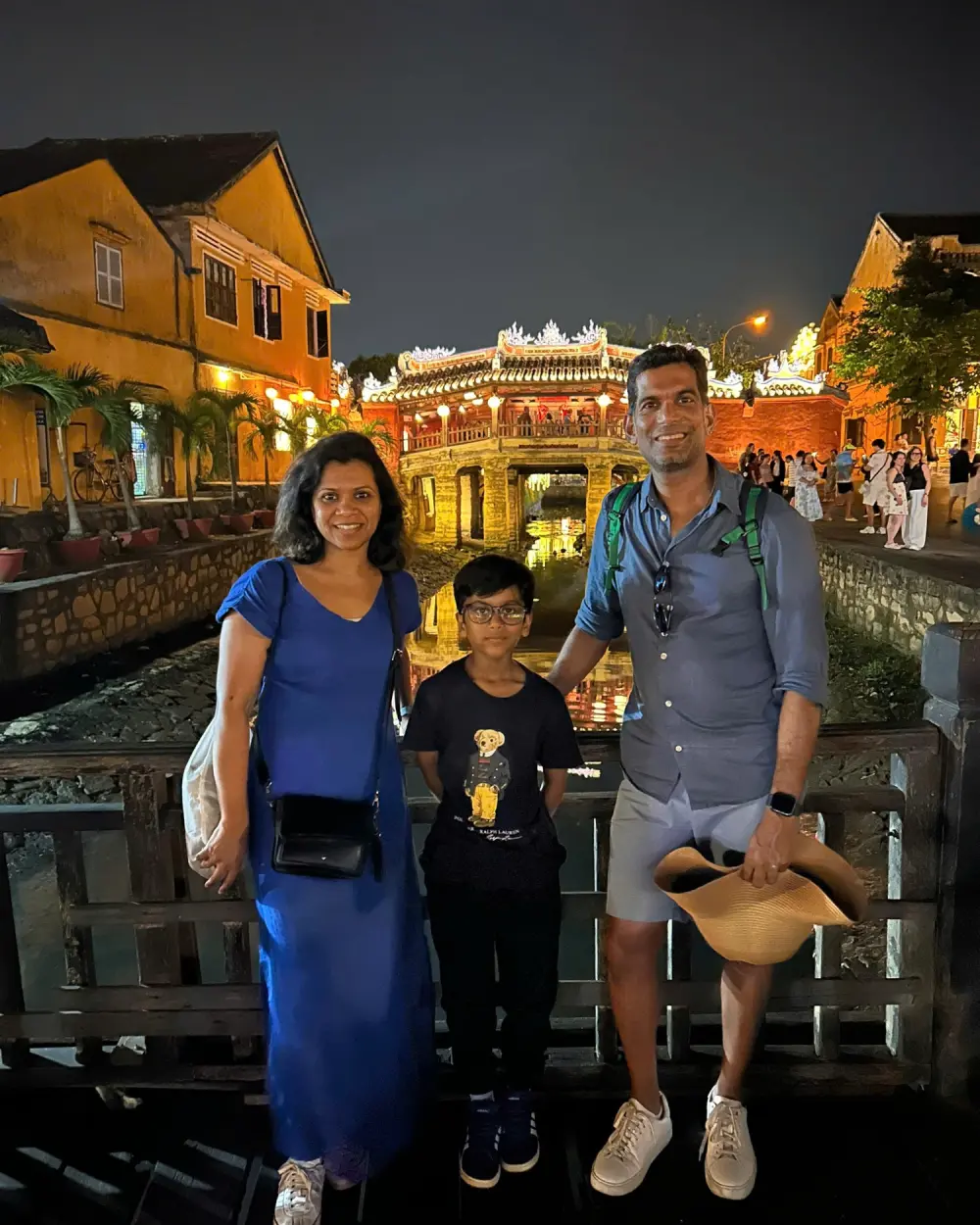 A family at the Japanese Covered Bridge in Hoi An at night
