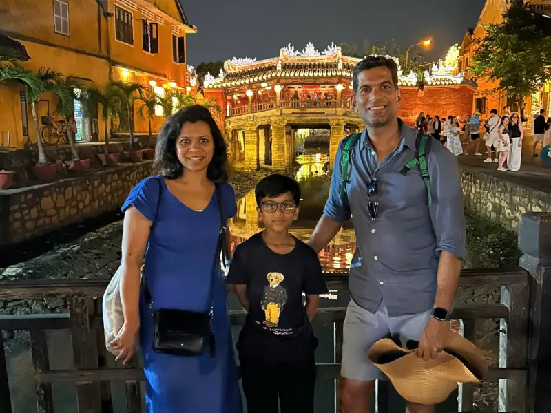 A family at the Japanese Covered Bridge in Hoi An at night