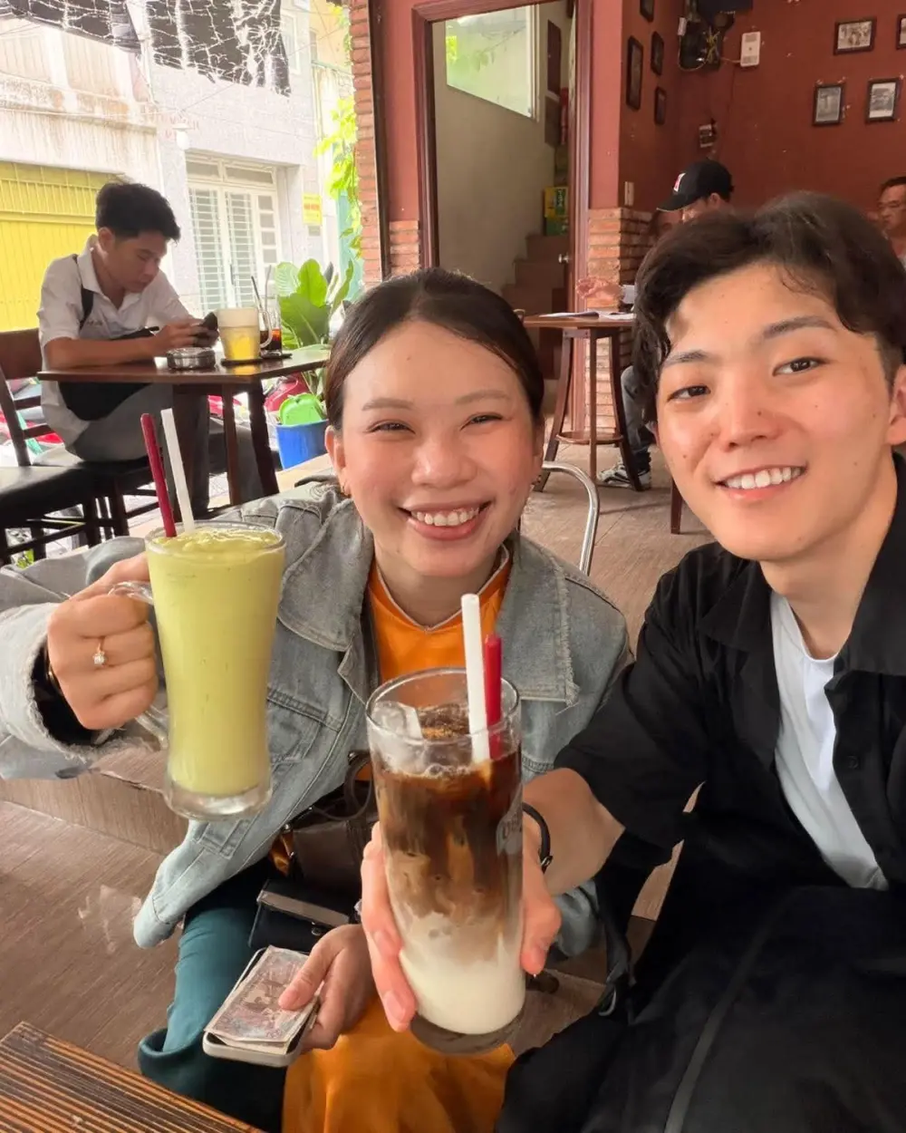 Two guests with Vietnamese coffee drinks at a café