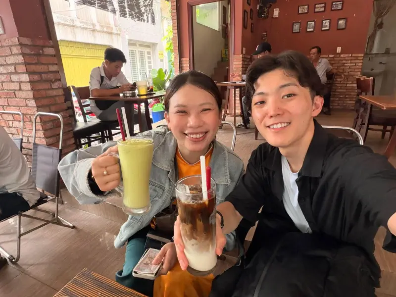 Two guests with Vietnamese coffee drinks at a café